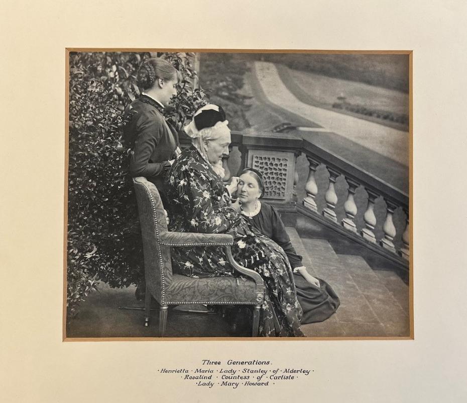 Lady Stanley, Lady Carlisle, and Lady Mary Howard posed on/around garden bench