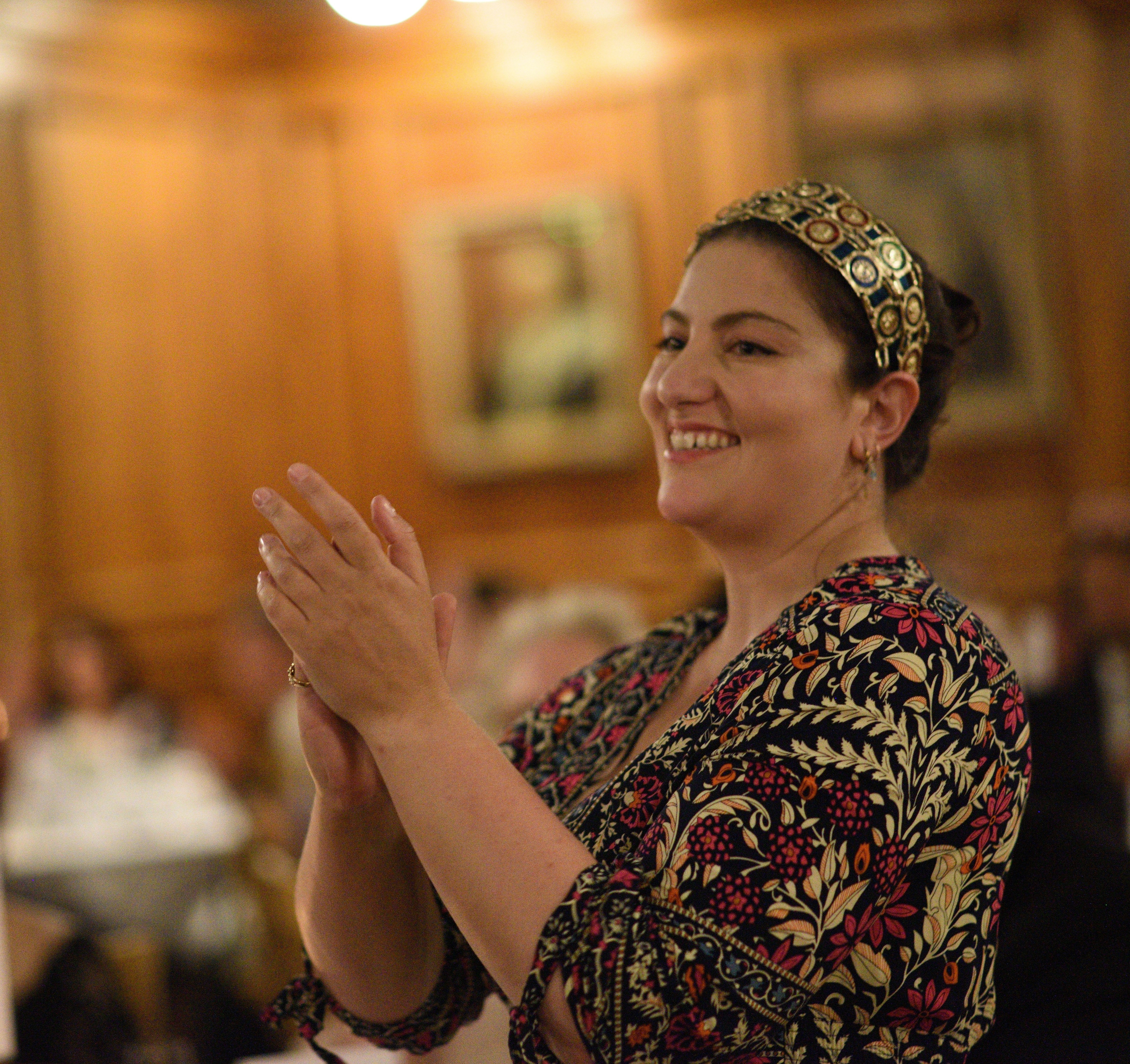 Cevanne Horrocks-Hopayian applauding in Great Hall, Girton College