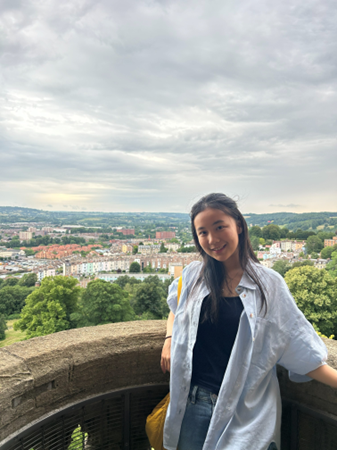 Amanda on a stone balcony overlooking a city. 