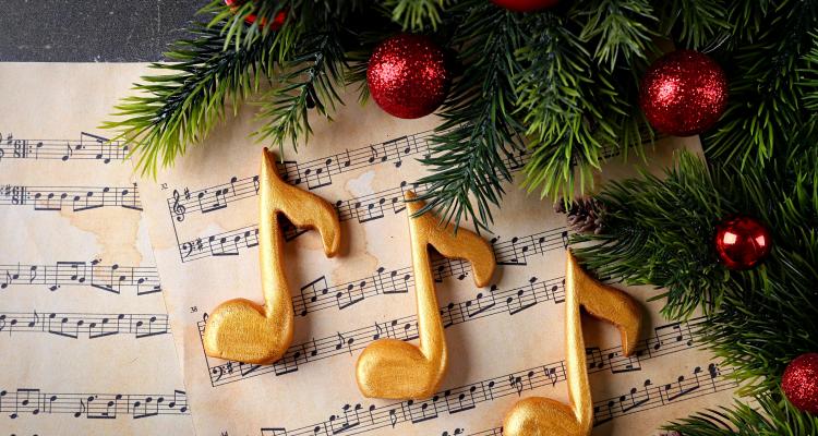 music sheet with music symbol, christmas tree branch, and baubles