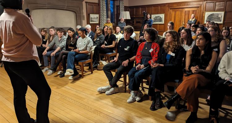 An image of the Geography Reunion from 2024. A speaker is stood at the front of students and alumni in the Fellows' Rooms.