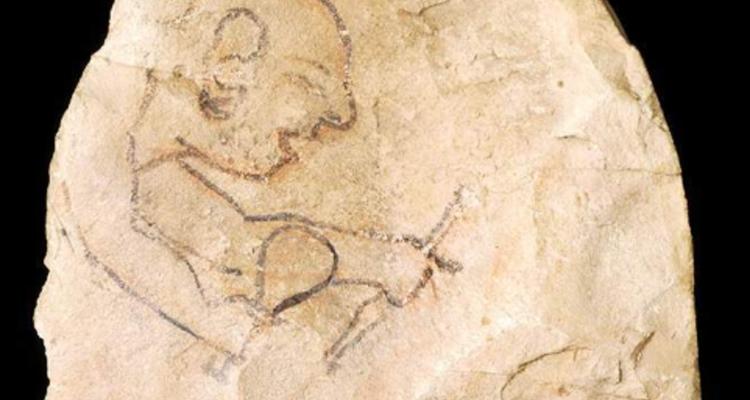 Image of a worker with tools drawn on a rock
