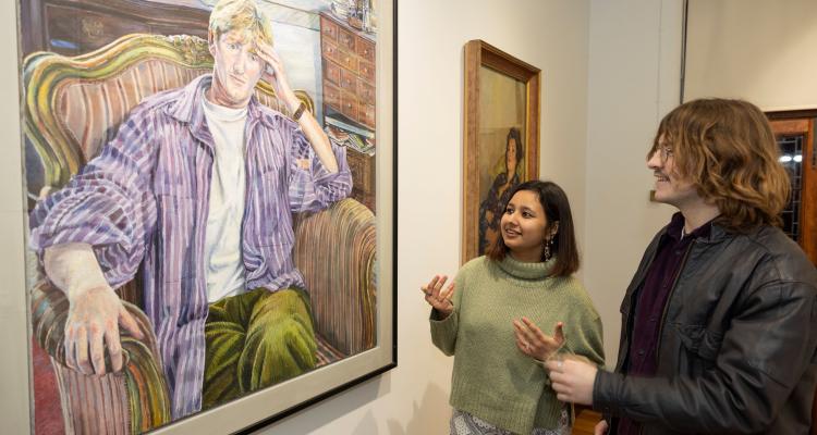 An image of visitors looking at the portraits collection