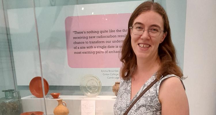 Emma Brownlee in front of the new exhibition at Museum of Archaeology and Anthropology 