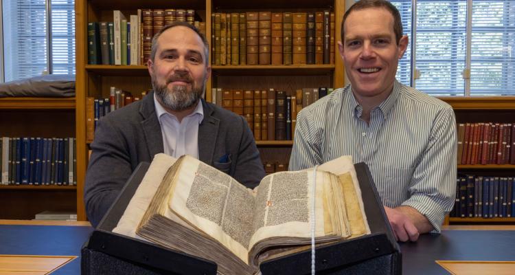 James Wade (left) and Seb Falk (right) with Peterhouse MS 255 open at the sermon in the University Library. Credit: University of Cambridge