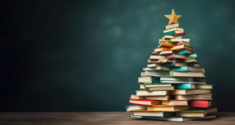 Stack of books shaped into a tree topped with a gold star
