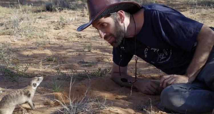 Dr Arik Kershenbaum communicating with wild meerkats in the Kalahari