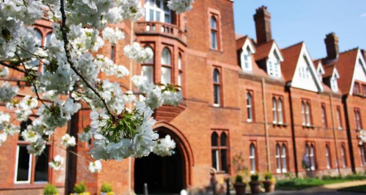 Photo of blossoms and the front of Girton College