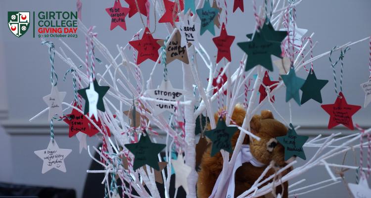 Girton wishing tree with handwritten messages on coloured stars.