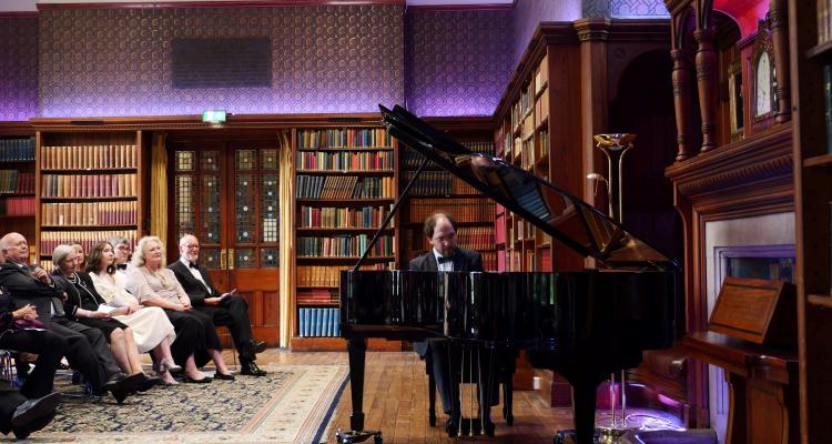 Pianist plays new Steinway grand piano in the Stanley Library for a gathered audience