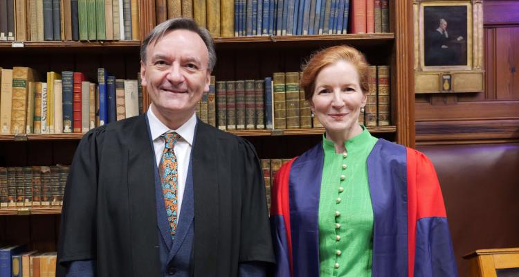 (L-R): Sir Stephen Hough and Dr Elisabeth Kendall in front of the book case in the Stanley Library at Girton College, Cambridge