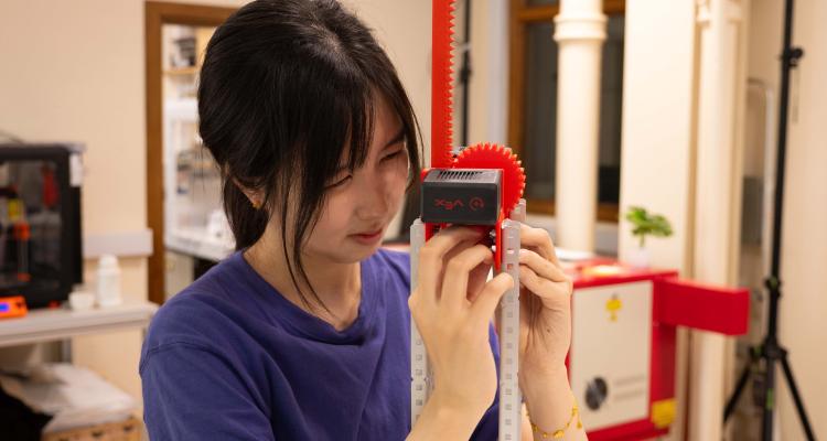 Engineering undergraduate, Nicole, working on her robot as part of a summer internship at the Cambridge University Engineering Department
