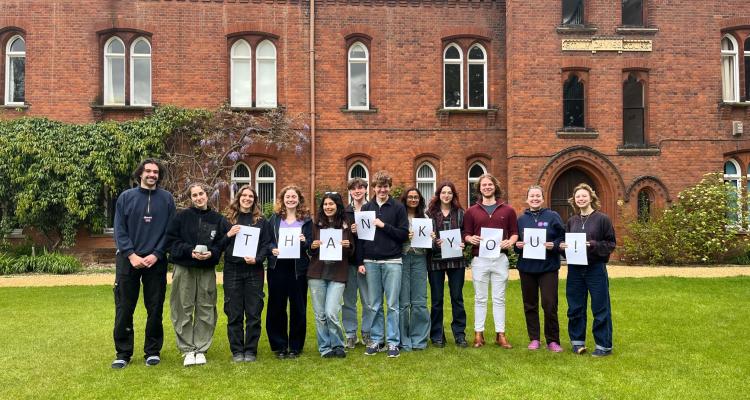 Twelve student callers holding a sign reading Thank You!