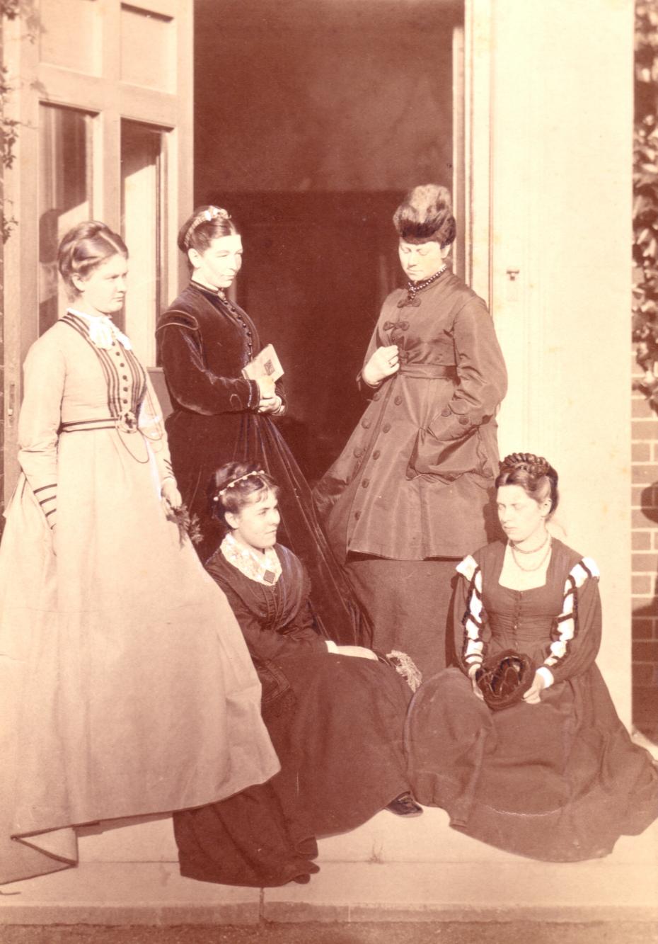 Caption: Photograph of the first five students at Hitchin, 1869. (Back Row, L to R): Sarah Woodhead; Anna Lloyd; Louisa Lumsden. (Seated, L to R): Emily Caroline Gibson; Isabella Townshend (archive reference: GCPH 7/2/1/2a).